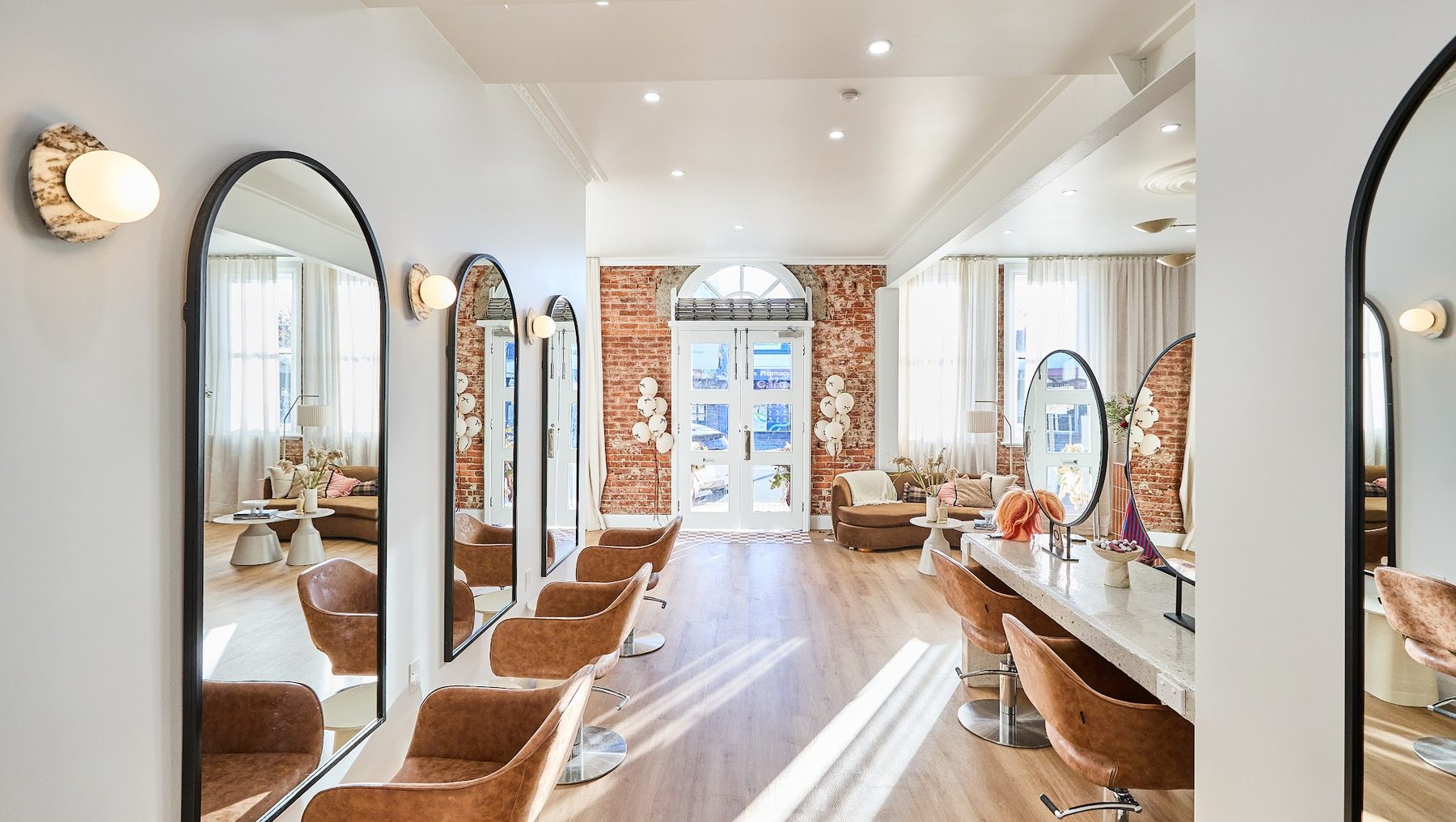 Inside Soul Hair Studio on Conadilly Street, looking down the styling stations towards the arched front doors