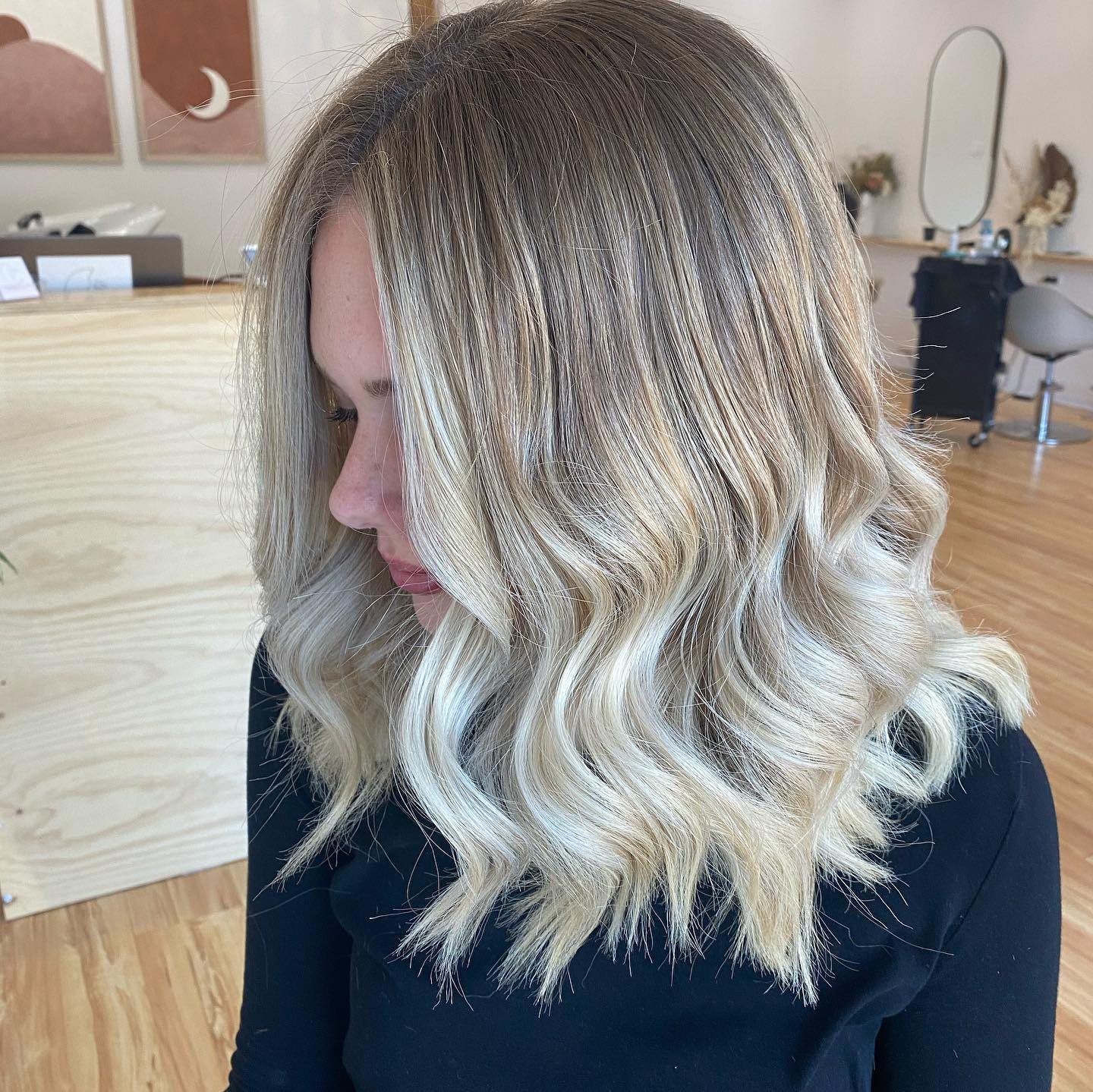 Cool toned blonde balayage, cut to a soft lob and curled
