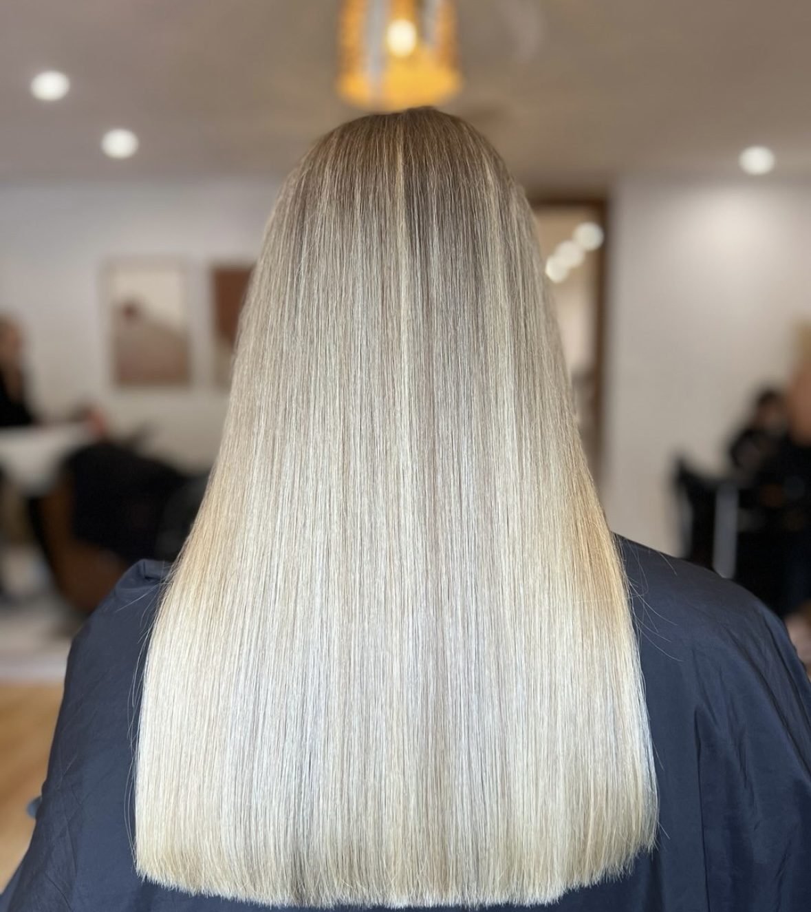 Long, very pale blonde worn straight, seen from behind
